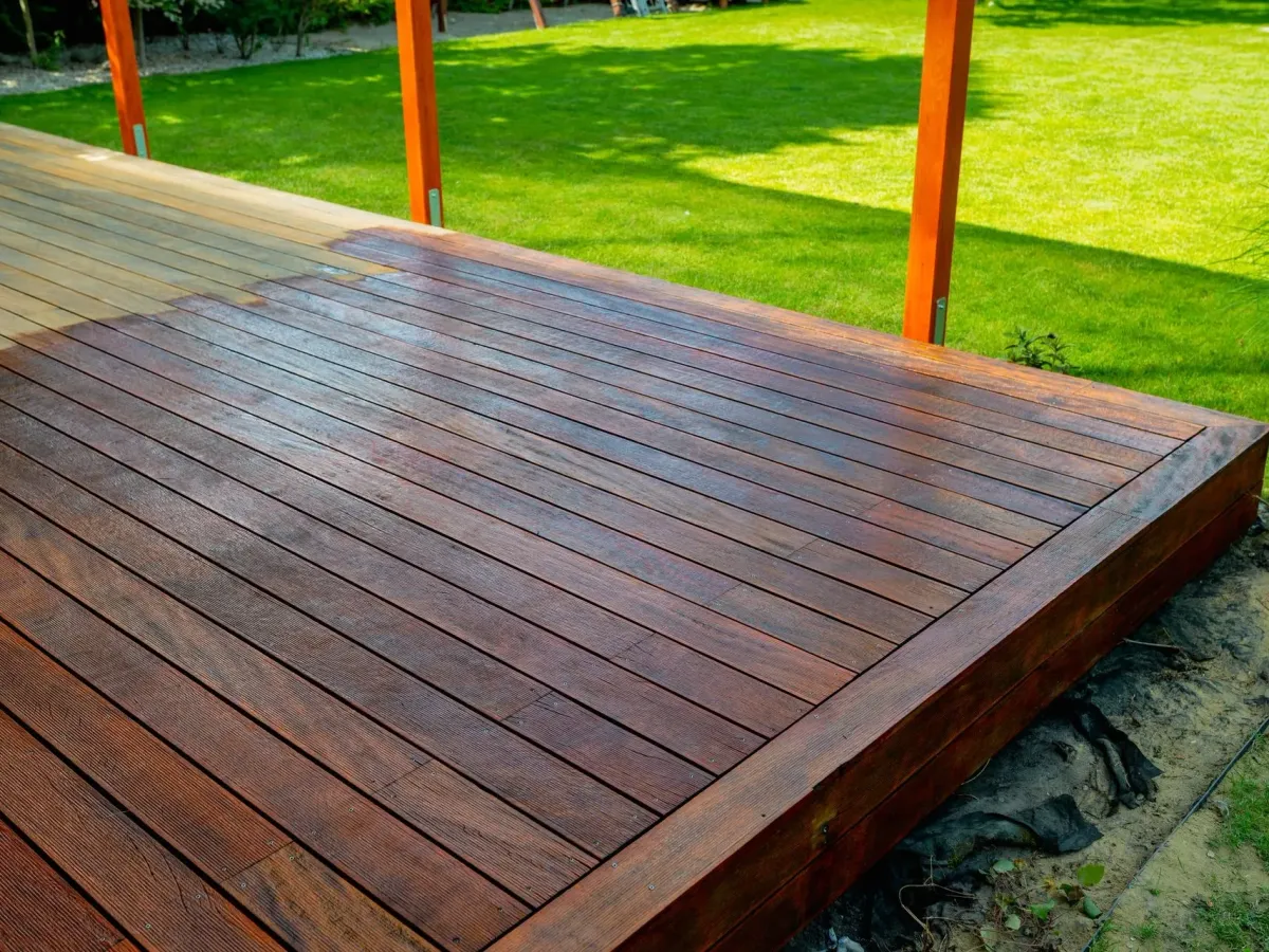 A freshly stained wooden deck on a lawn — porch and deck surfaces in New Bedford, MA