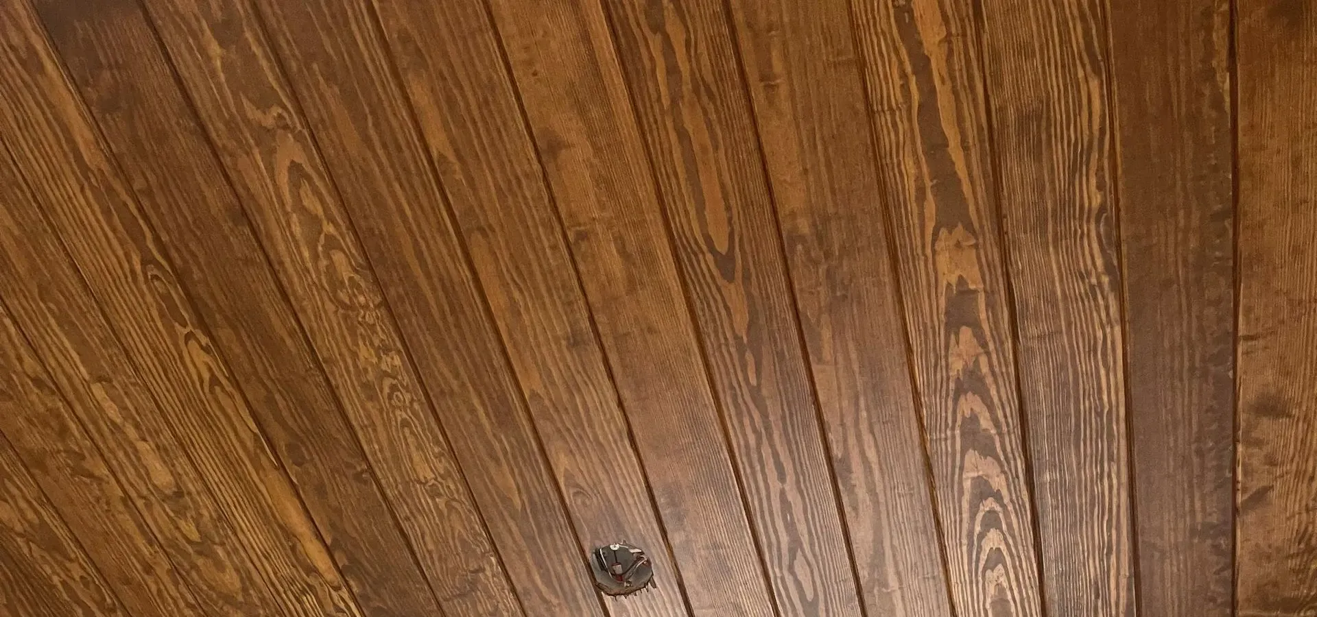 A stained wood plank ceiling — finish work in New Bedford, MA