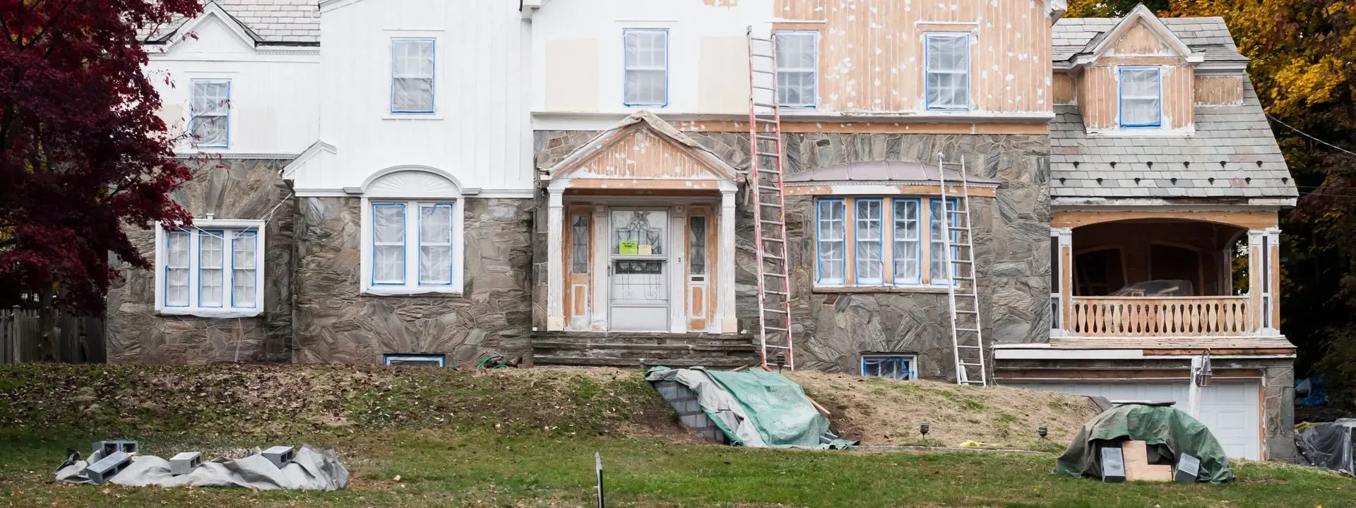 The stone lower storey of a large house during exterior work — masonry in New Bedford, MA